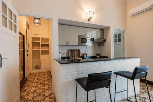 a kitchen with a counter and two chairs in a room at Junior Suite Balima I B43 in Rabat