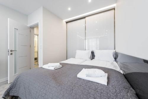 a bedroom with a large bed with towels on it at Sweet tiny top center space in Varna City