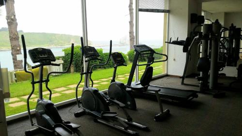 a gym with a row of exercise bikes in front of a window at Algarrobo Apartment in Algarrobo