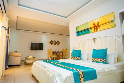een slaapkamer met een groot bed en een tv bij 520 hôtel & Résidence in Abidjan