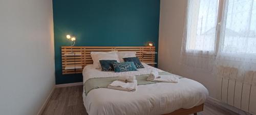 sypialnia z łóżkiem z 2 lalkami w obiekcie Auva - SILS Maison 48 m2 à 5 minutes à pied de la plage w mieście Saint-Aubin-sur-Mer