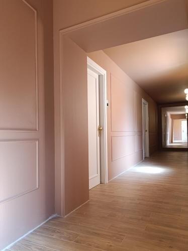 an empty hallway of an empty house with a door at I Mecenati in Macerata