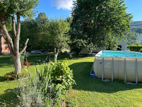 a swimming pool in the yard of a house at Apartments Celopek in Ličko Petrovo Selo