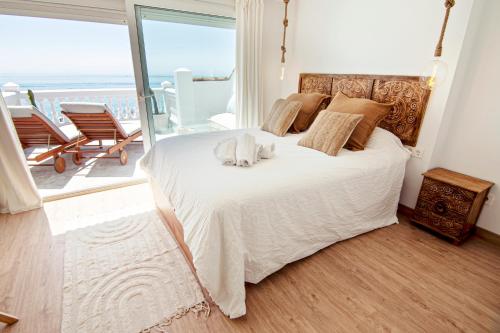 a bedroom with a bed with a view of the ocean at Mara's Apartments Torremolinos SeaViews -Beachfront - Duplex Penthouse in Torremolinos