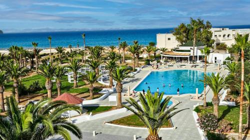 an aerial view of a resort with a pool and the ocean at Monarque El Fatimi Mahdia in Mahdia
