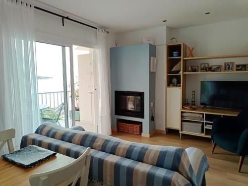 a living room with two couches and a television at FONOLL MARÍ - ROSES FAR in Roses
