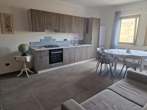 a kitchen with a table and a dining room at Nina's house 5 a 300 mt dal mare in Santa Caterina Dello Ionio Marina