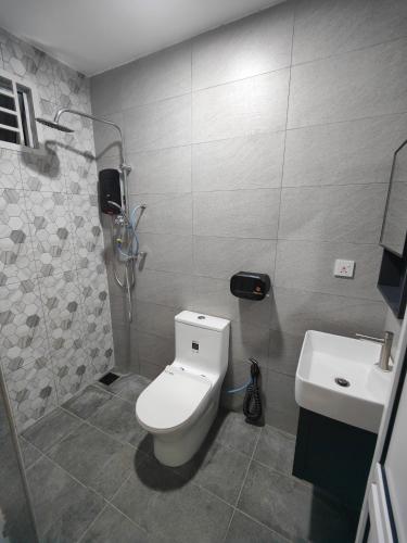 a bathroom with a toilet and a sink at Villa with private pool in Melaka