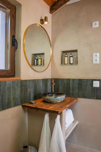a bathroom with a sink and a mirror at Casa da Azeitona T1 - Monte do Serrado de Baixo in Évora
