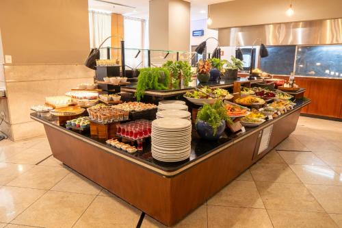 a buffet line with many different types of food at Hotel Nacional Inn Jaragua Sao Paulo in Sao Paulo