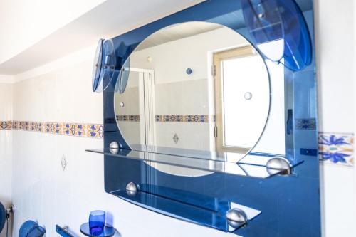 a bathroom with a blue mirror and a sink at Casa vacanze da Nicola in Saponara Villafranca