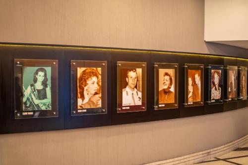 a row of framed photos offamous actors on a wall at Hotel Nacional Inn Jaragua Sao Paulo in Sao Paulo