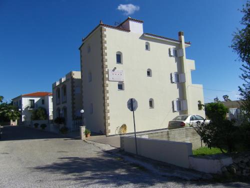 a large white building on the side of a street at Hotel Filioppi in Agios Kirykos