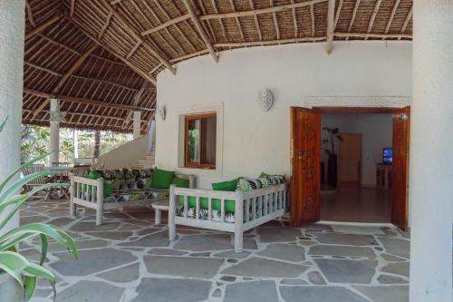a room with two benches and a table at Baobab Village in Watamu