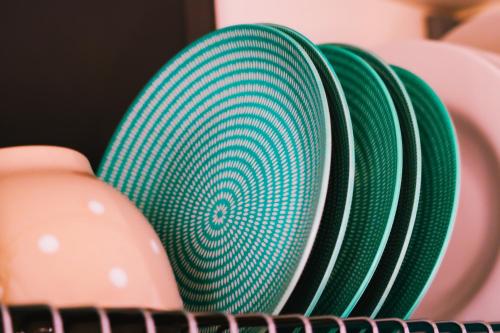a stack of green and white plates sitting next to each other at Sunrise Vergia Apartments in Vergia