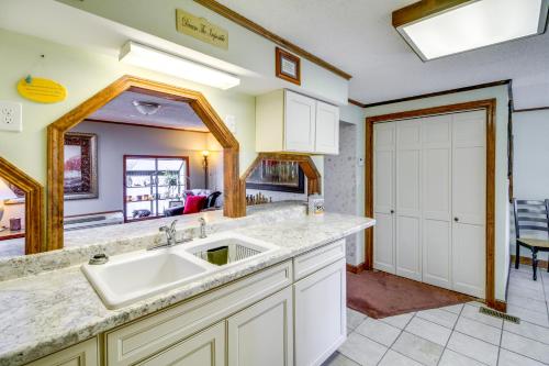 a kitchen with a sink and a large mirror at Bull Shoals Lake Home at Beaver Creek Marina! in Kissee Mills