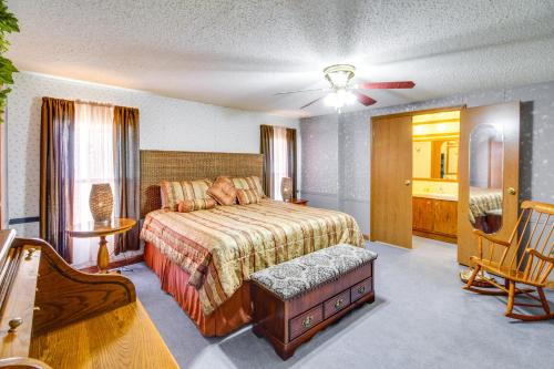 a bedroom with a bed and a chair in it at Bull Shoals Lake Home at Beaver Creek Marina! in Kissee Mills