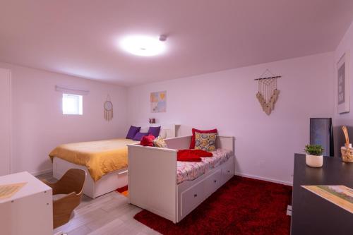 a bedroom with a bed and a couch in it at Perafita Yellow House - EcoHost in Perafita
