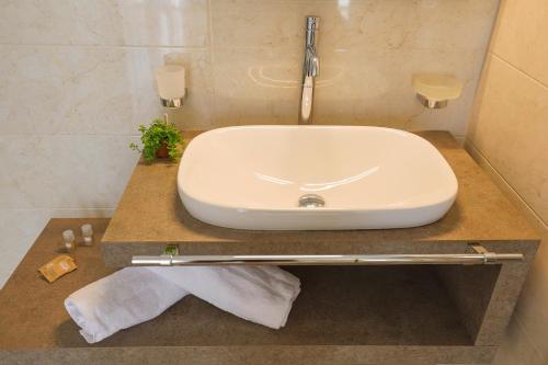 a bathroom with a white sink on a counter at Dimore Relais - Suite Garden Breakfast in Porto Cesareo
