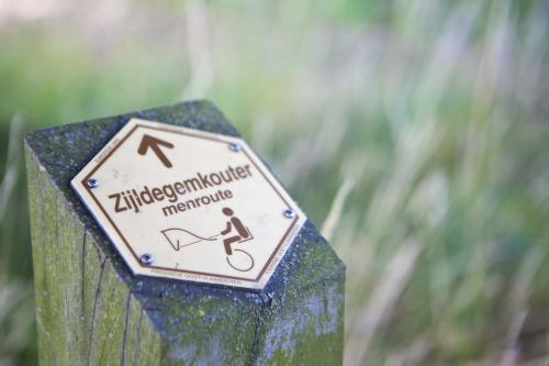a sign on the side of a post at Lozerkasteel in Kruishoutem