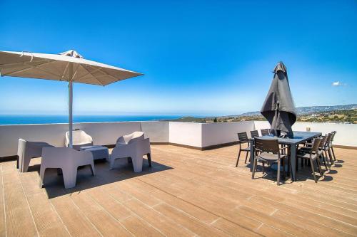 a patio with a table and chairs and an umbrella at Tala Sea View 205 in Tala