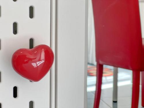 a red heart on a door with a red chair at Amalfi Rooms Duoglio Beach -amazing seaview in Amalfi