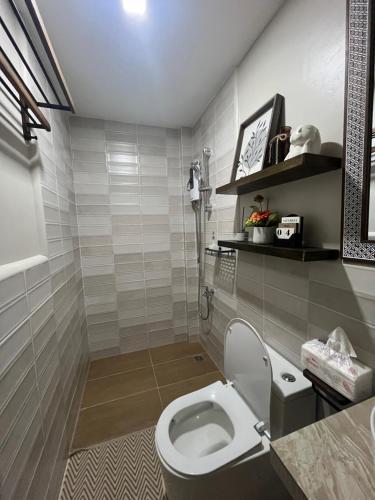 a bathroom with a toilet and a sink at Balay na Bato in Legazpi