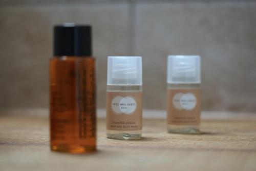 three bottles of essential oils sitting on a table at Dimore Relais - Suite Garden Breakfast in Porto Cesareo
