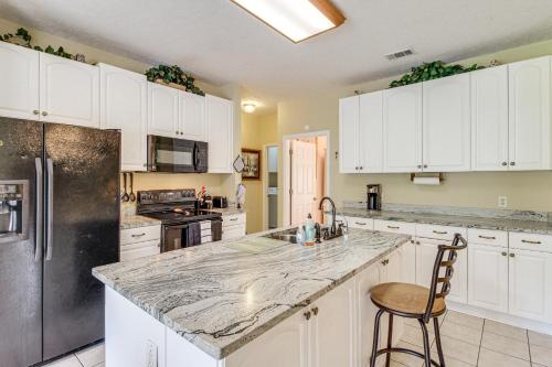 a kitchen with white cabinets and a granite counter top at Spacious Richmond Hill Hideaway with Deck! in Richmond Hill