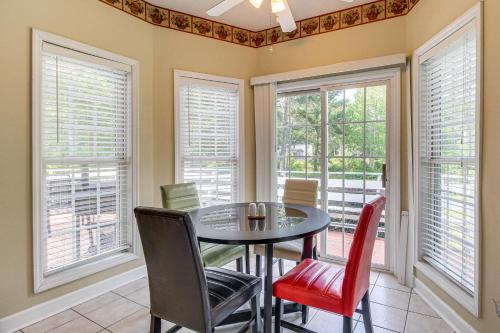 a dining room with a table and chairs and windows at Spacious Richmond Hill Hideaway with Deck! in Richmond Hill