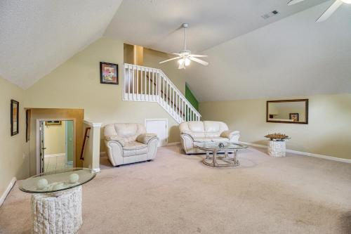 a living room with two chairs and a staircase at Spacious Richmond Hill Hideaway with Deck! in Richmond Hill