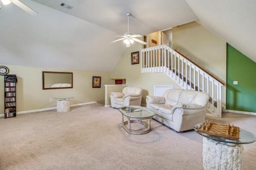 a living room with two chairs and a staircase at Spacious Richmond Hill Hideaway with Deck! in Richmond Hill