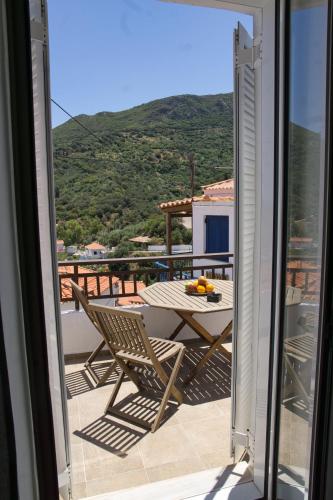 a patio with a table and chairs on a balcony at Velanidia Homestay in Velanídhia