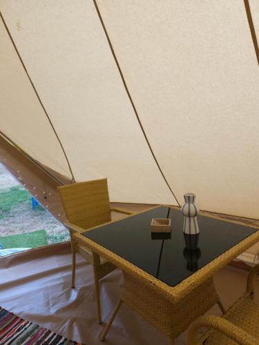 a table and chairs in a room with a tent at Ioannina Camping- Glamping in Neo Mpizani
