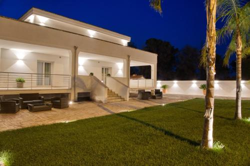 a villa with a swimming pool at night at Dimore Relais - Suite Garden Breakfast in Porto Cesareo