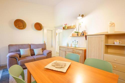 a living room with a table and a couch at Agriturismo La Genziana in Alghero