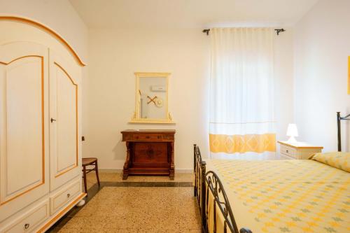 a bedroom with a bed and a dresser at Agriturismo La Genziana in Alghero