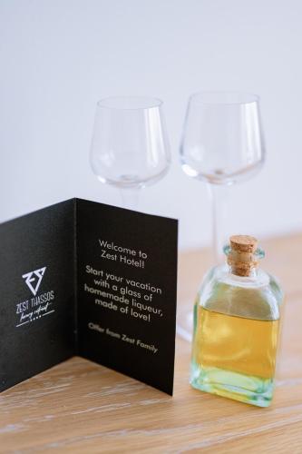 a bottle of whiskey next to two wine glasses at ZEST THASSOS LUXURY RETREAT in Limenaria