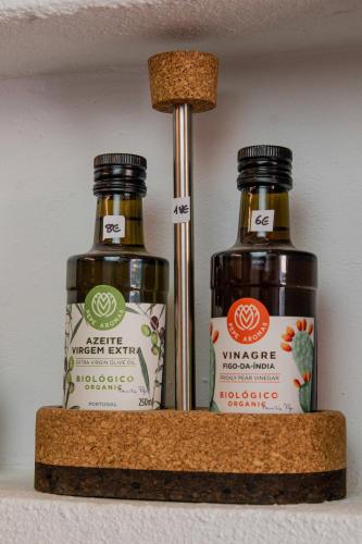 two bottles of vinegar sitting on a shelf at Monte do Serrado De Baixo in Évora