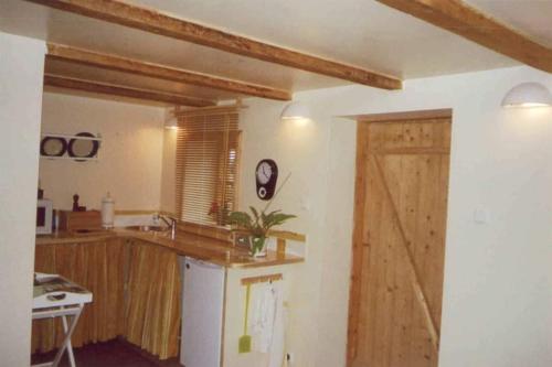 a kitchen with a counter and a wooden door at Nilseni in Jelgava