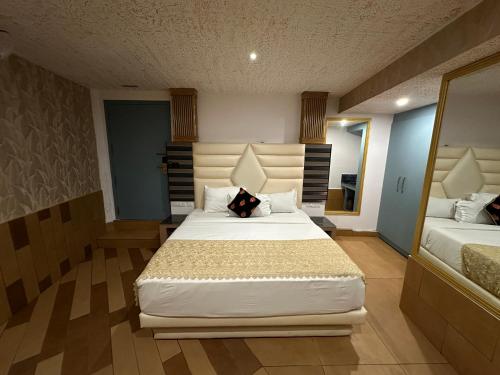 a bedroom with a large bed with a pillow on it at Parakkat Nature Resort in Munnar