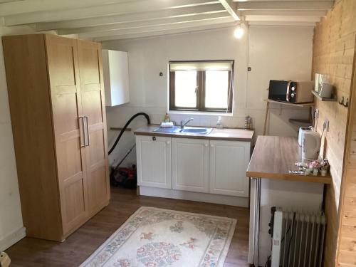 a small kitchen with a sink and a window at Vigo Retreat cabin 3 in Sevenoaks