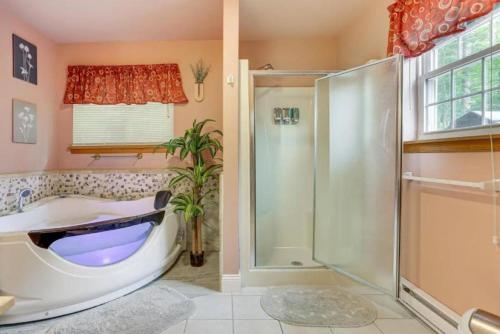 a bathroom with a large tub and a shower at Charming, Restful Getaway in Bushkill