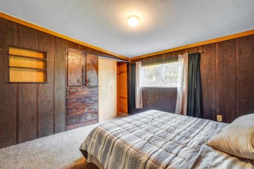a bedroom with a bed and a window at Table Rock Lake Cabin with Deck and Bar! in Shell Knob