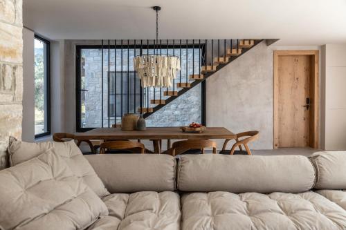 a living room with a couch and a table at Nikoleta Hotel and Villas in Limenas