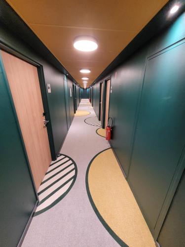 a hallway with escalators and stairs in a train at Hôtel AKENA Strasbourg - Hoerdt in Hoerdt