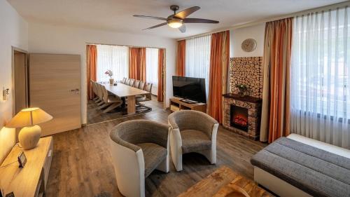 a living room with a couch and a table with a fireplace at Ferienhaus City Ferienhaus Daun in Daun