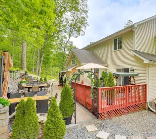a house with a red fence and a patio at Charming, Restful Getaway in Bushkill