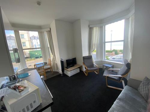 a living room with a couch and a tv at Farina No2, Sea view apartment sleeping 4 guests in Bridlington