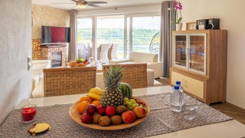 a bowl of fruit on a table in a living room at Ferienwohnung Maarpanorama in Schalkenmehren am See in Schalkenmehren